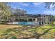 Inviting screened pool with lush backyard, perfect for outdoor entertaining and relaxation in a private setting at 6514 Sunhigh Dr, New Port Richey, FL 34655