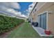 Backyard view of home with a green lawn and concrete patio at 6902 47Th N Ln, Pinellas Park, FL 33781