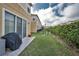 Backyard view of home featuring a green lawn and a covered grill at 6902 47Th N Ln, Pinellas Park, FL 33781