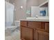 Bathroom with tile floor, toilet, and sink with wooden cabinet at 6902 47Th N Ln, Pinellas Park, FL 33781