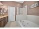 Bathroom featuring a shower, soaking tub, and double vanity at 6902 47Th N Ln, Pinellas Park, FL 33781