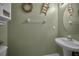 Charming half bath with green walls, ladder decor, and white fixtures at 6902 47Th N Ln, Pinellas Park, FL 33781
