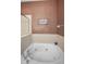 Close up of tub with jets, tile surround, and decorative sign at 6902 47Th N Ln, Pinellas Park, FL 33781