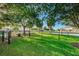 Nicely manicured and fenced dog park with mature landscaping and green space for residents and their pets at 6902 47Th N Ln, Pinellas Park, FL 33781