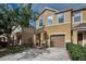 Charming two-story townhome with neutral stucco exterior, single car garage, and manicured front lawn in a quiet neighborhood at 6902 47Th N Ln, Pinellas Park, FL 33781