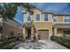 Charming two-story townhome with tan stucco exterior, attached garage, and well-maintained landscaping at 6902 47Th N Ln, Pinellas Park, FL 33781