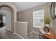 Upper hallway with carpet, neutral paint, and an arched doorway leading to a bedroom at 6902 47Th N Ln, Pinellas Park, FL 33781