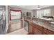 Kitchen with granite countertops, stainless steel appliances, views to the living room and open floor plan at 6902 47Th N Ln, Pinellas Park, FL 33781