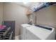 A laundry room with modern white appliances and shelving for organizing supplies at 6902 47Th N Ln, Pinellas Park, FL 33781