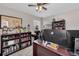 Well lit office with built-in bookshelves, multiple monitors and ceiling fan at 6902 47Th N Ln, Pinellas Park, FL 33781