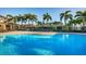 Enjoy a refreshing swim in this beautiful community pool surrounded by lush tropical landscaping and lounge chairs at 6902 47Th N Ln, Pinellas Park, FL 33781