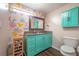 Bathroom with granite vanity, teal cabinets, modern wallpaper, and wood-look flooring at 7108 N Howard Ave, Tampa, FL 33604