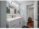 Well-lit bathroom with stylish vanity, decorative mirror, and black and white tiled floor at 7108 N Howard Ave, Tampa, FL 33604