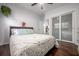 Bedroom with laminate flooring, neutral bedding, natural light, and closet with sliding glass doors at 7108 N Howard Ave, Tampa, FL 33604