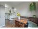 Cozy dining nook featuring a wooden table, built-in seating, and a view into the adjacent kitchen at 7108 N Howard Ave, Tampa, FL 33604