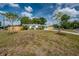Ranch-style home featuring a well-maintained lawn, a new fence, and a charming exterior at 7108 N Howard Ave, Tampa, FL 33604