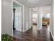Hallway with hardwood floors leading to bedrooms and closets, offering seamless transitions at 7108 N Howard Ave, Tampa, FL 33604
