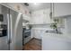 Bright kitchen with stainless steel appliances, white cabinets, and modern countertops and backsplash at 7108 N Howard Ave, Tampa, FL 33604