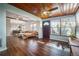 Inviting open-concept living room with hardwood floors, sunroom, and comfortable seating at 7108 N Howard Ave, Tampa, FL 33604