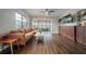 Open living room with hardwood floors, custom shelving, and a bright sunroom at 7108 N Howard Ave, Tampa, FL 33604