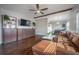 Stylish living room featuring hardwood floors, custom shelving, and comfortable leather seating at 7108 N Howard Ave, Tampa, FL 33604