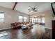 Inviting living room with hardwood floors, beam ceilings, modern furnishings, and cozy sunroom at 7108 N Howard Ave, Tampa, FL 33604