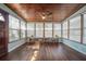 Bright sunroom with hardwood floors, wood ceilings, and plenty of windows at 7108 N Howard Ave, Tampa, FL 33604