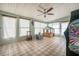 Bright sunroom featuring a ceiling fan, tiled floors, and windows offering ample natural light at 7108 N Howard Ave, Tampa, FL 33604