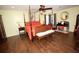 Spacious bedroom featuring a four-poster bed, wooden furniture, and warm, inviting decor at 7120 Early Gold Ln, Riverview, FL 33578