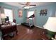 Bedroom with wood floors, ceiling fan, desk and treadmill at 7120 Early Gold Ln, Riverview, FL 33578