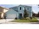 Charming two-story home with manicured lawn and attached garage at 7120 Early Gold Ln, Riverview, FL 33578