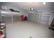 Spacious two car garage featuring sealed flooring, storage cabinets and a partially open door at 7120 Early Gold Ln, Riverview, FL 33578