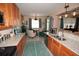 Bright kitchen with granite counters, wood cabinets, stainless appliances with seating to the dining area at 7120 Early Gold Ln, Riverview, FL 33578