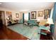Inviting living room featuring a hardwood floor, plush seating, and tasteful decor at 7120 Early Gold Ln, Riverview, FL 33578