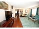 Inviting living area featuring a large television, comfortable seating, and access to other areas of the home at 7120 Early Gold Ln, Riverview, FL 33578