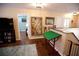 Open loft area featuring wood floors, neutral walls, and decorative artwork with access to other rooms at 7120 Early Gold Ln, Riverview, FL 33578