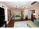 Spacious loft with ample lighting, hardwood floors, a small safety gate, and access to multiple rooms at 7120 Early Gold Ln, Riverview, FL 33578