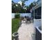 Paver patio features a table and chairs for outdoor entertaining with a white vinyl fence surrounding the backyard at 7120 Early Gold Ln, Riverview, FL 33578