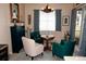 Cozy sitting area with four chairs and a round table, illuminated by a chandelier, perfect for conversation at 7120 Early Gold Ln, Riverview, FL 33578