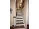 Staircase showcasing wood stairs, white risers, and a wooden handrail at 7120 Early Gold Ln, Riverview, FL 33578