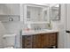 A bathroom featuring white cabinets, a dark wood vanity, a white countertop and tiled walls at 7337 Glasgow Rd, Weeki Wachee, FL 34613