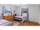 Bright bedroom with hardwood floors, dual windows, and a charming, whimsical decor at 7337 Glasgow Rd, Weeki Wachee, FL 34613