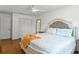 This is a bedroom with a double closet, wood floors, and a ceiling fan at 7337 Glasgow Rd, Weeki Wachee, FL 34613