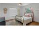 Cozy bedroom with natural light, wood floors, neutral walls, and decorative accents at 7337 Glasgow Rd, Weeki Wachee, FL 34613