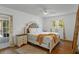 Spacious bedroom featuring a ceiling fan, wood floors, and a scenic outdoor view at 7337 Glasgow Rd, Weeki Wachee, FL 34613