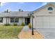 Well-maintained home featuring a front door entry with a walkway and landscaped yard at 7337 Glasgow Rd, Weeki Wachee, FL 34613