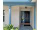 Welcoming front entryway with a stylish door, brick accents, and manicured landscaping at 7337 Glasgow Rd, Weeki Wachee, FL 34613