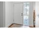 Bright entryway with a traditional white front door and decorative sidelight window at 7337 Glasgow Rd, Weeki Wachee, FL 34613