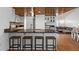 Open concept kitchen with granite counters, wood ceiling, bar seating, and stainless steel appliances at 7337 Glasgow Rd, Weeki Wachee, FL 34613