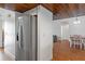 Stainless steel refrigerator in kitchen with wood ceiling and view to dining area at 7337 Glasgow Rd, Weeki Wachee, FL 34613
